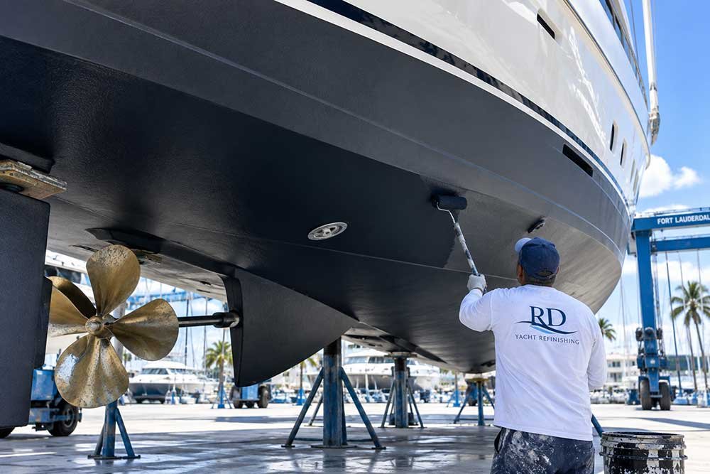 Antifouling bottom paint being applied to a yacht hull